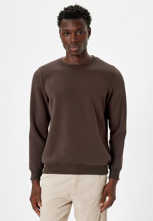 Brun sweatshirt lavet af blødt stof, med rund halsudskæring, lange ærmer, ribbede manchetter og en lige kant. Enkel, sømløs design.