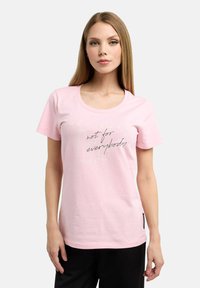 Light pink cotton t-shirt with round neckline, short sleeves, and text print reading "not for everybody" in contrasting colors.