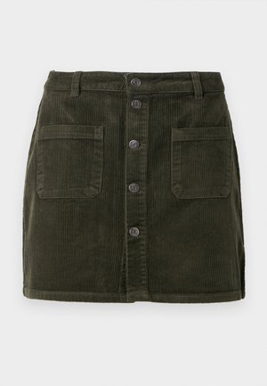 Green corduroy mini skirt with a button front, two front pockets, and a textured surface. Features a fitted waist and straight cut.