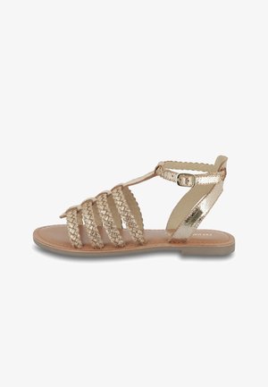 Sandalen met bandjes in metallic roségoud. Kenmerkt zich door gevlochten banden, enkelgesp, platte zool en een soepel leren binnenzool.