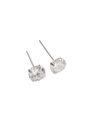 Silver stud earrings featuring oval clear gemstones with multiple facets, set in a secure prong setting, reflecting light.