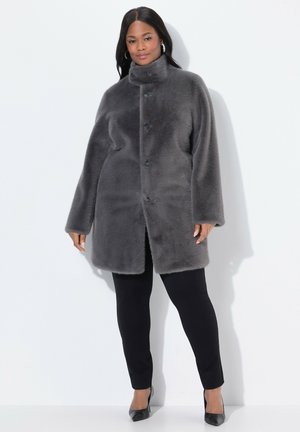 Gray faux fur coat with a high collar, front button closure, and side pockets. Worn over black pants and shoes, features a soft texture.