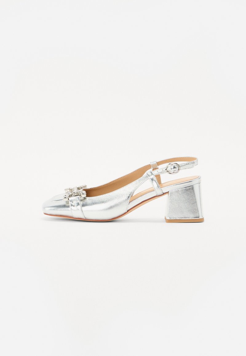 Silver slingback shoe with a shiny metallic finish, a low block heel, and decorative embellishments on the toe. Features an adjustable strap.