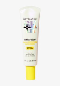 Tube de crème solaire avec un corps blanc, un capuchon jaune, un texte holographique et des lettres noires. L'étiquette indique "Sunray Glow, SPF 50+", 50 ml.