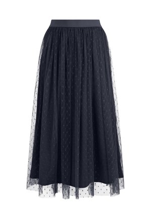 Jupe midi noire avec taille froncée, superposée d'un tulle transparent à pois, créant une silhouette texturée et fluide.
