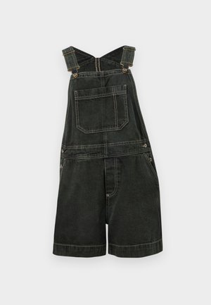 Melni džinsa īsie kombinezoni ar priekšu piešūtu kabatu, regulējamām plecu siksnām, sānu pogām un platām kāju daļām uz balta fona.