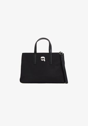 Schwarze Nylon-Tote mit zwei oberen Griffen, Reißverschluss und silbernem Akzent, der das Gesicht eines Charakters mit Sonnenbrille zeigt. Glatte Textur.