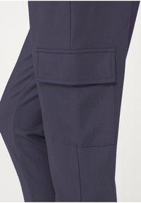 Navy blue cargo pants made from a smooth, textured fabric featuring a prominent, flat front pocket on the thigh.