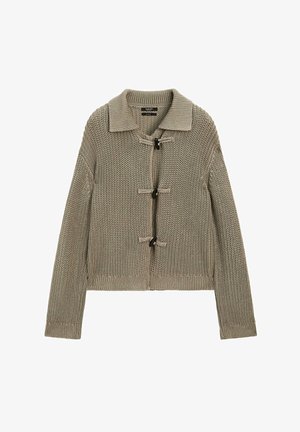 Knit cardigan in muted beige with a collar, toggles for closure, and ribbed cuffs. Textured fabric with an open-knit pattern throughout.