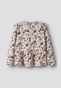 Blommig långärmad topp med en beige bakgrund, lila och blå blommönster, volangdetaljer på axlarna och en peplum föll.