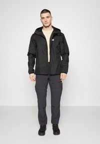 Helly Hansen ERVIK - Regenjas - black