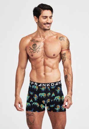 Shorts de boxeur noirs avec un imprimé animal multicolore vibrant. Fabriqués en tissu extensible avec une taille élastique étiquetée "FRANK DANDY".