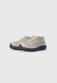 Light gray athletic shoes with mesh upper, round toe, textured rubber sole, and dark blue accents along the sole and logo.