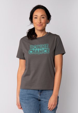 Grijze katoenen t-shirt met "BONNE CHANCE" in vette turquoise letters. Slim fit ontwerp met korte mouwen en een ronde hals.