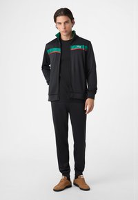 Fila SAGANO REGULAR - Träningsbyxor - black