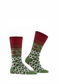 Grüne und rote Socken mit einem Design von Schneeflocken und Rentieren, mit einem gerippten oberen Bereich und gemustertem Fuß. Hergestellt aus gestricktem Stoff.