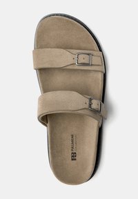 Brown suede sandals with two adjustable straps and silver buckles. Black sole with textured surface and branding on footbed.