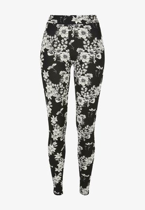 Mustad mustrid, millel on valge lillemuster, venivast kangast, kõrge vöökoht lisamugavuse ja sobivuse jaoks.