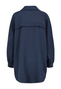 Navy blue long-sleeve shirt made from textured fabric, featuring a collar, and a back yoke detail. Includes buttoned cuffs.