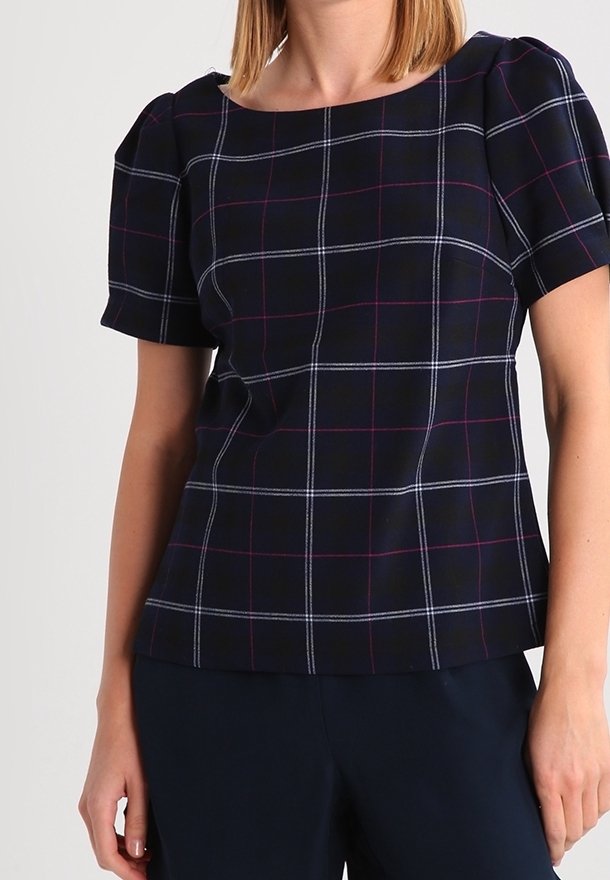 Navy blue short-sleeve top with a plaid pattern in white and light purple. Features a square neckline and smooth fabric texture.