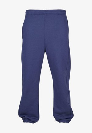 Pantalones de chándal azul marino hechos de tejido suave, con cinturilla y puños elásticos, un corte relajado y bolsillos laterales.