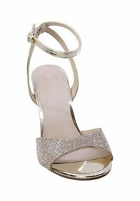 Sandali con cinturino alla caviglia in oro metallico, punta aperta e una fascia di strass brillanti sul davanti. Sottopiede beige liscio.