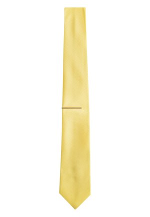 Yellow textured fabric necktie with a narrow gold tie clip, displayed flat on a white background.