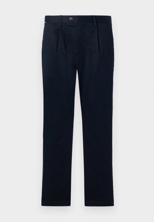 Navy blue cotton trousers with a straight leg design, featuring a front pleat, button closure, and minimalistic styling.