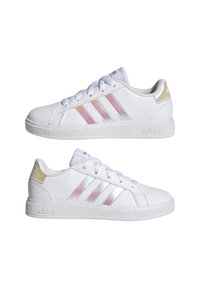 White sneakers with three iridescent stripes, smooth synthetic material, round toe, and textured rubber outsole. Features lace-up closure.