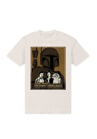 Béžové tričko s grafickou potiskem Boba Fetta, Hana Sola a R2-D2 s nápisem "THE EMPIRE STRIKES BACK" ve spodní části.