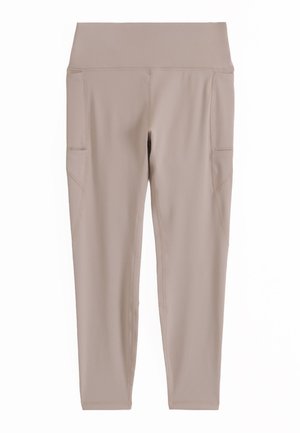 Beige high-waist leggings with side pockets, smooth fabric, and fitted ankle-length design.