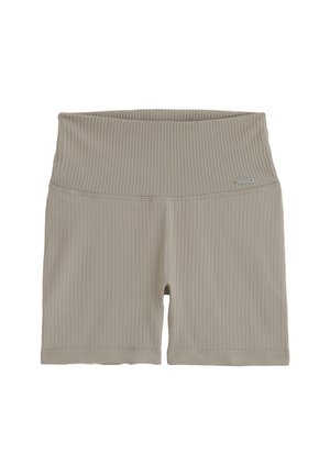 Béžové žebrované cyklistické šortky s vysokým pasem a malou kovovou značkou na levé straně pásku.