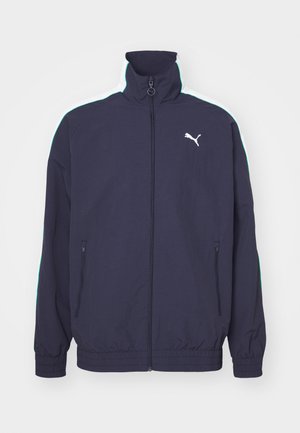 Marinejacke mit hohem Kragen, Frontreißverschluss, Seitentaschen und kontrastierenden weißen und mintgrünen Streifen auf den Schultern. Mit Logo-Akzent.