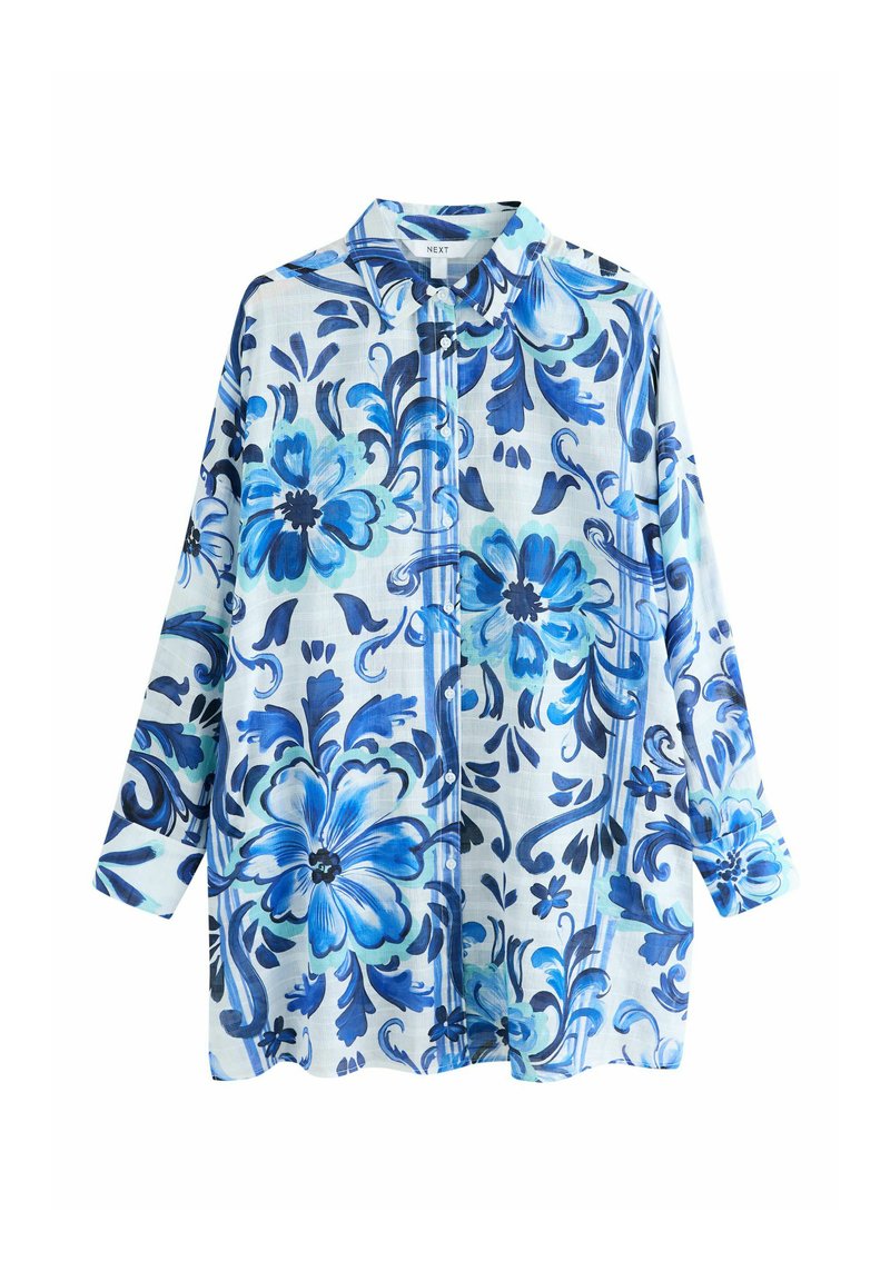 Overhemd met lange mouwen en knopen, voorzien van een blauw bloemenpatroon op een lichte achtergrond. Gemaakt van lichtgewicht stof met een kraag.