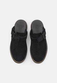 Scarpe slip-on in suede nero con una larga fascia e chiusura a strappo, suola in gomma spessa e logo stampato sulla soletta.