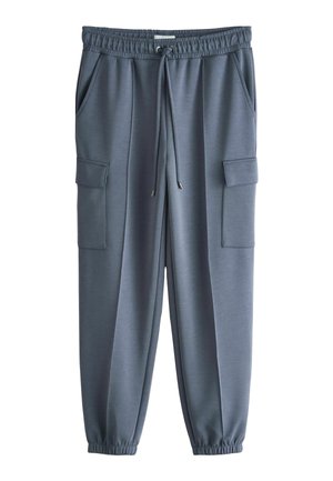 Grå joggebukser med elastisk talje, snøre, to forlommer, to store klaplommer og elastiske manchetter.