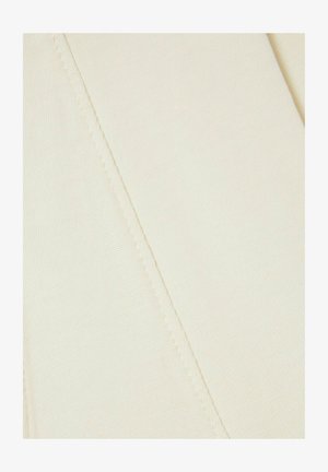 Cream-colored fabric with a textured weave, featuring visible stitching and a smooth, soft surface. The material appears lightweight and flexible.