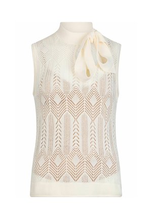 Haut sans manches en maille crème avec motif en losange, col montant et grand nœud noué sur l\'épaule gauche.