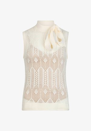 Haut sans manches en maille crème avec motif en losange, col montant et grand nœud noué sur l\'épaule gauche.