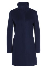 Navy wool blend coat with a high collar, straight cut, and long sleeves. Features clean lines and minimal detailing for a sleek design.