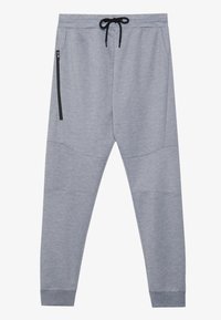 Grå joggers med en mjuk textur, elastisk midja, svart dragsko, sidoficka med blixtlås och paneldetaljer längs benen.