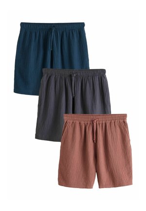 Three pairs of textured fabric shorts in blue, dark gray, and terracotta, each with an elastic waistband and front drawstring.
