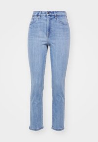 Höga ljusblå slim fit jeans med knapplås, framfickor och bältesöglor, uppvisade mot en vit bakgrund.