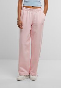 Lyserøde sweatpants med elastisk talje, sidelommer og detaljer med trykt logo. Lavet af blødt stof med en afslappet pasform.