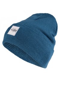 Blue knitted beanie hat with a folded brim, featuring a white woven label with black script. The texture is smooth and tightly woven.