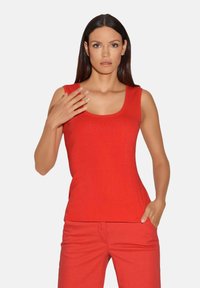 Rode mouwloze top met een ronde hals, gemaakt van ribbelstof, gecombineerd met bijpassende rode broek. Eenvoudig ontwerp met een getailleerde silhouet.