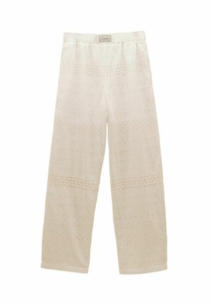 Cream wide-leg pants with elastic waistband and decorative eyelet lace patterns throughout the fabric.