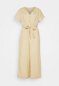 Gul blommig overall med korta ärmar, knäppning framtill och bälte vid midjan. Har vida ben och lätt tygkvalitet.