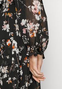 DKNY V NECK DRESS WITH ASYMMETRIC RUFFLE HEM - Day dress - black/multi