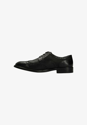 Chaussure habillée en cuir noir avec design à l'anglaise, détails perforés et finition lisse, dotée d'une semelle noire basse et d'un bout rond.